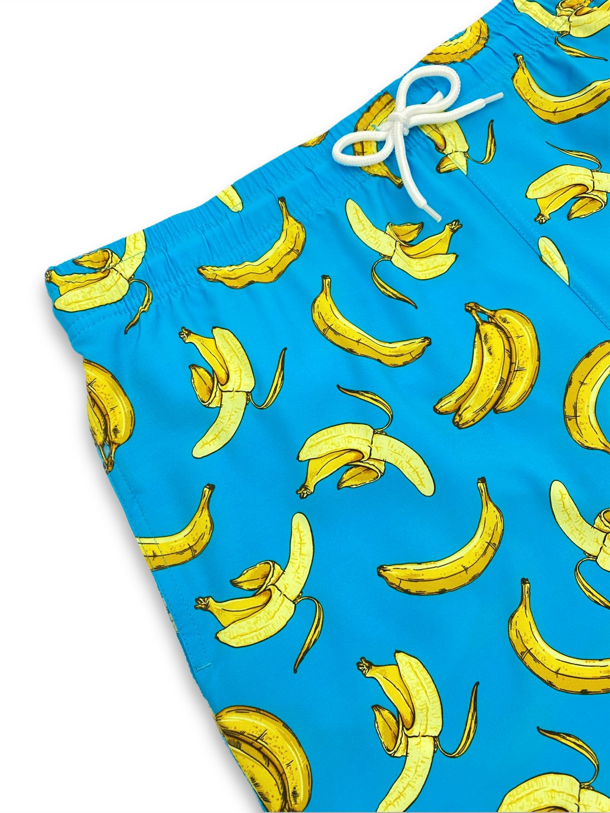 Macro shot of cyan blue swim shorts with yellow banana pattern and drawstring