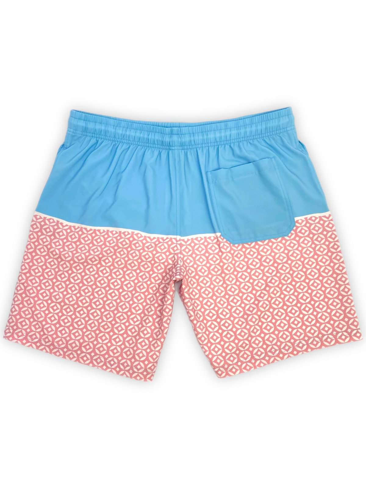 Full back view of two-tone light blue and salmon pink geometric circle pattern boardshorts